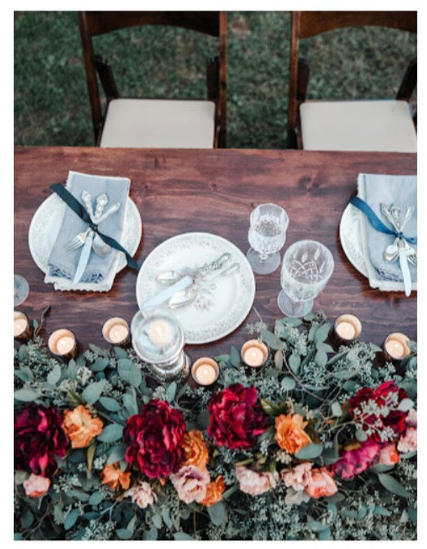 Outdoor wedding place setting on wooden table