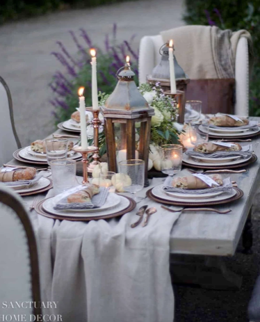 Outdoor dining table with china, lanterns and candles