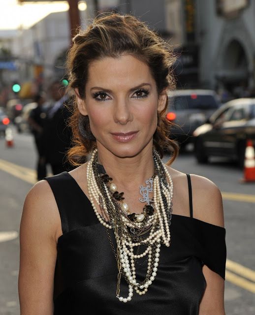 Actress Sandra Bullock wearing a cluster of pearl necklaces
