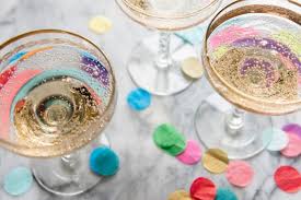 Champagne glasses and multi-colored paper confetti