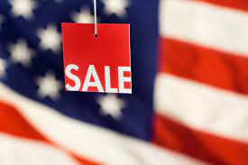 Sale sign with flag background