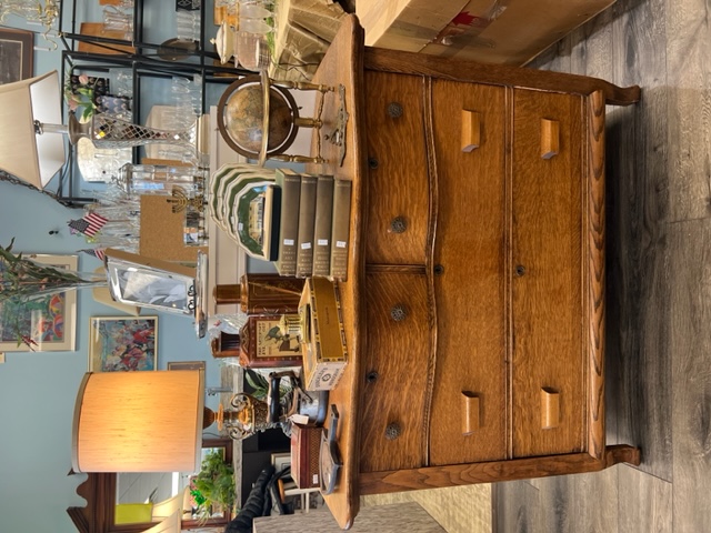 Wood dresser with vintage home decor displayed on top